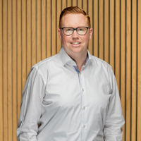 Headshot of man in white shirt